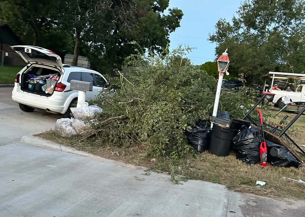 Vehicle loaded with debris being hauled off a property